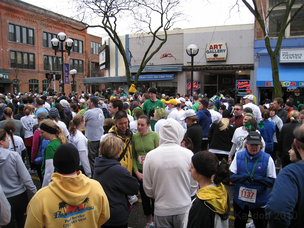 Shamrocks and Shenanigans 5K 2010 0150.jpg - The 2010 Shamrocks and Shenanigans 5K race in Ann Arbor MI. Cool and damp, and crowded. One tall Irishman in the center.